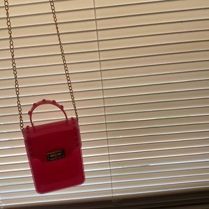 A strap pink purse real pretty real cute . Please buy it